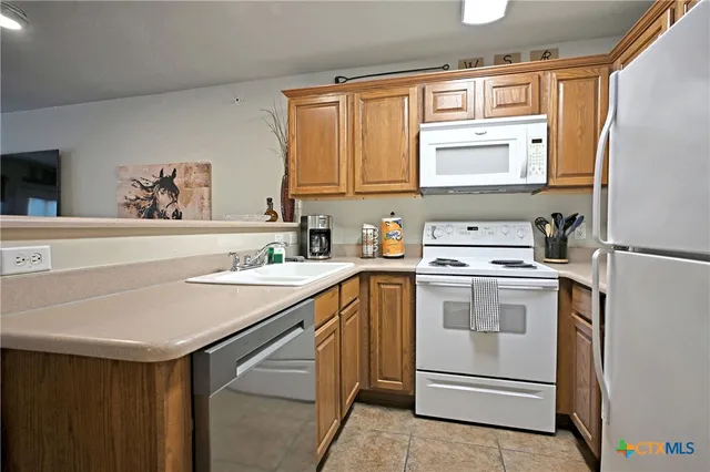 a kitchen with a sink stove and refrigerator