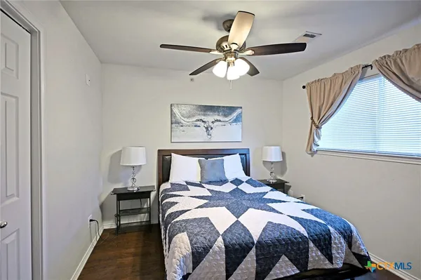 a bedroom with a bed and window