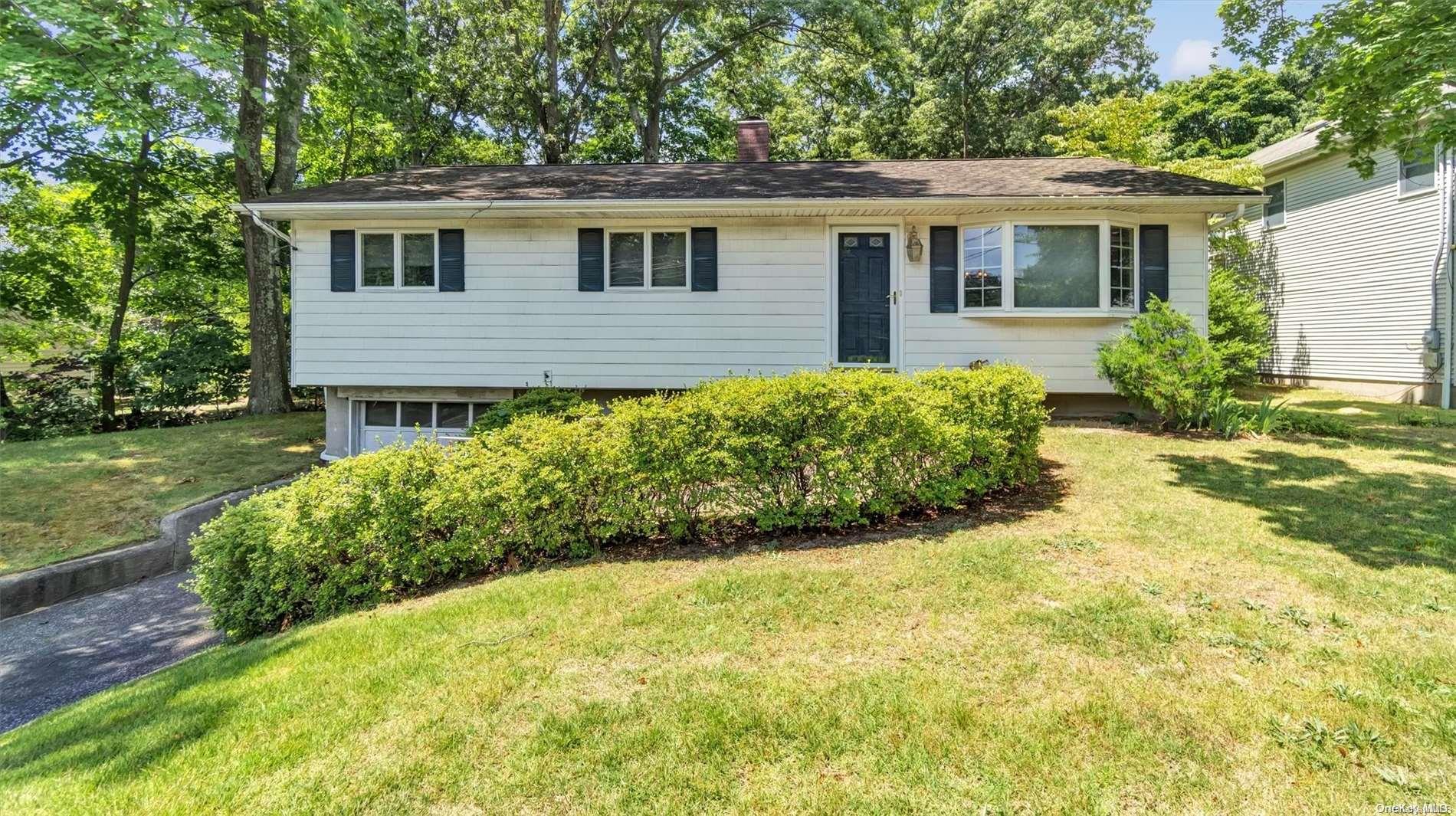 a view of a house with a yard and potted plants