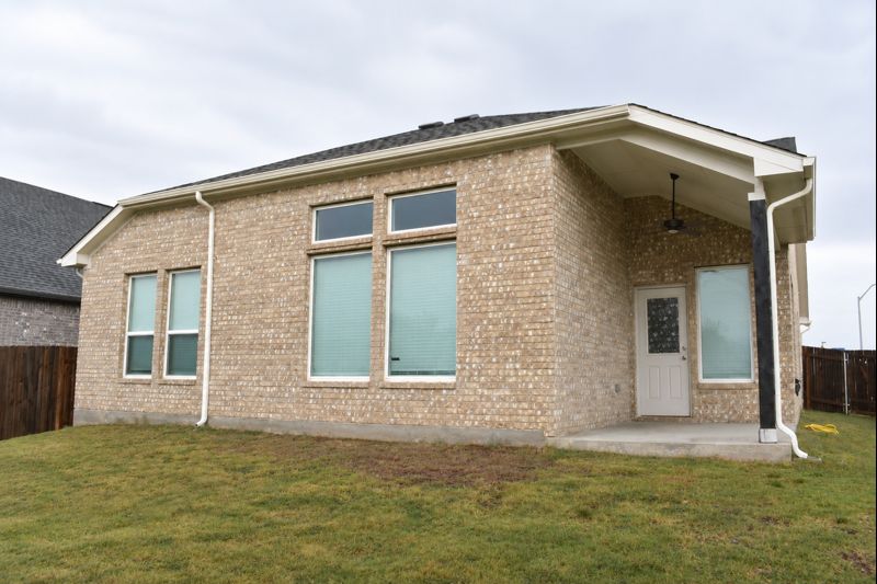 693 Durian Loop Buda, TX 78610 - Photo 19 of 27 Discover a private yard with a covered patio, perfect for outdoor enjoyment.