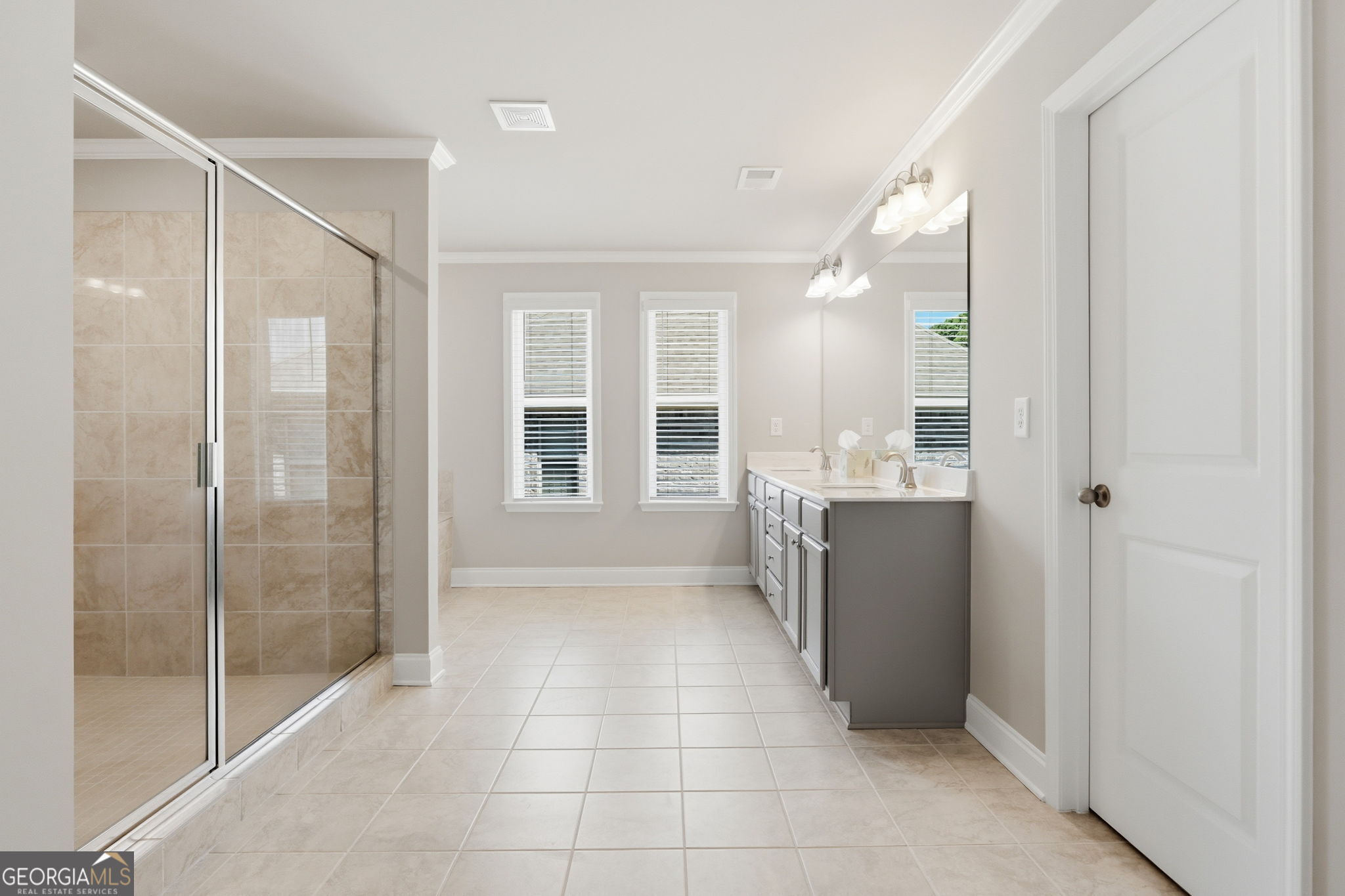 604 O'Brians Path McDonough, GA 30253 - Photo 22 of 41 a bathroom with a granite countertop sink a mirror and a shower