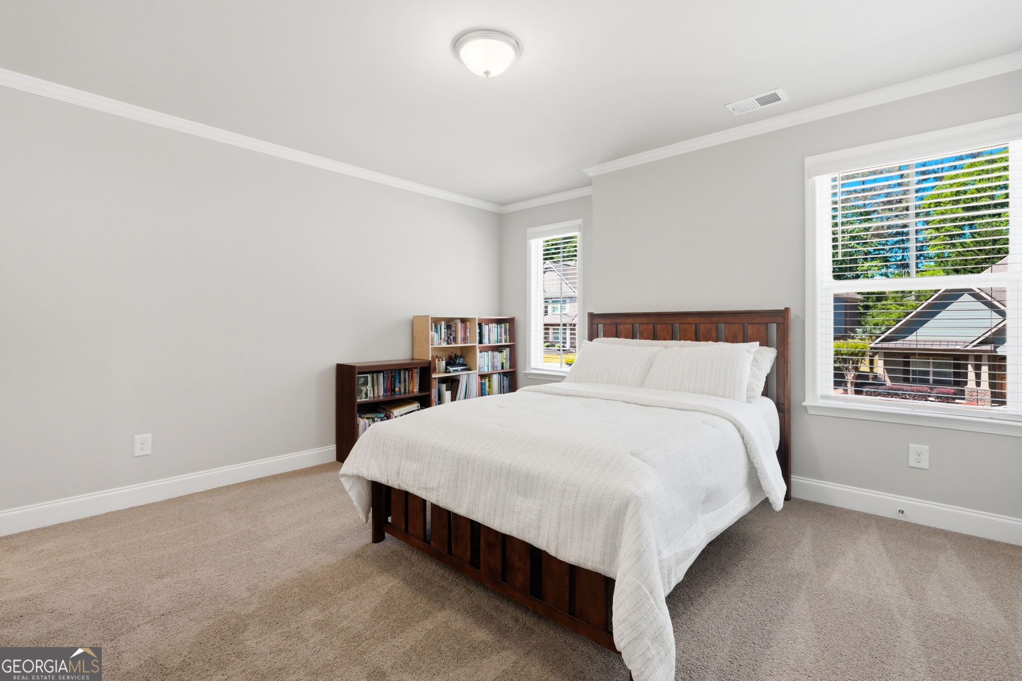 604 O'Brians Path McDonough, GA 30253 - Photo 29 of 41 a bed sitting in a bedroom next to a window