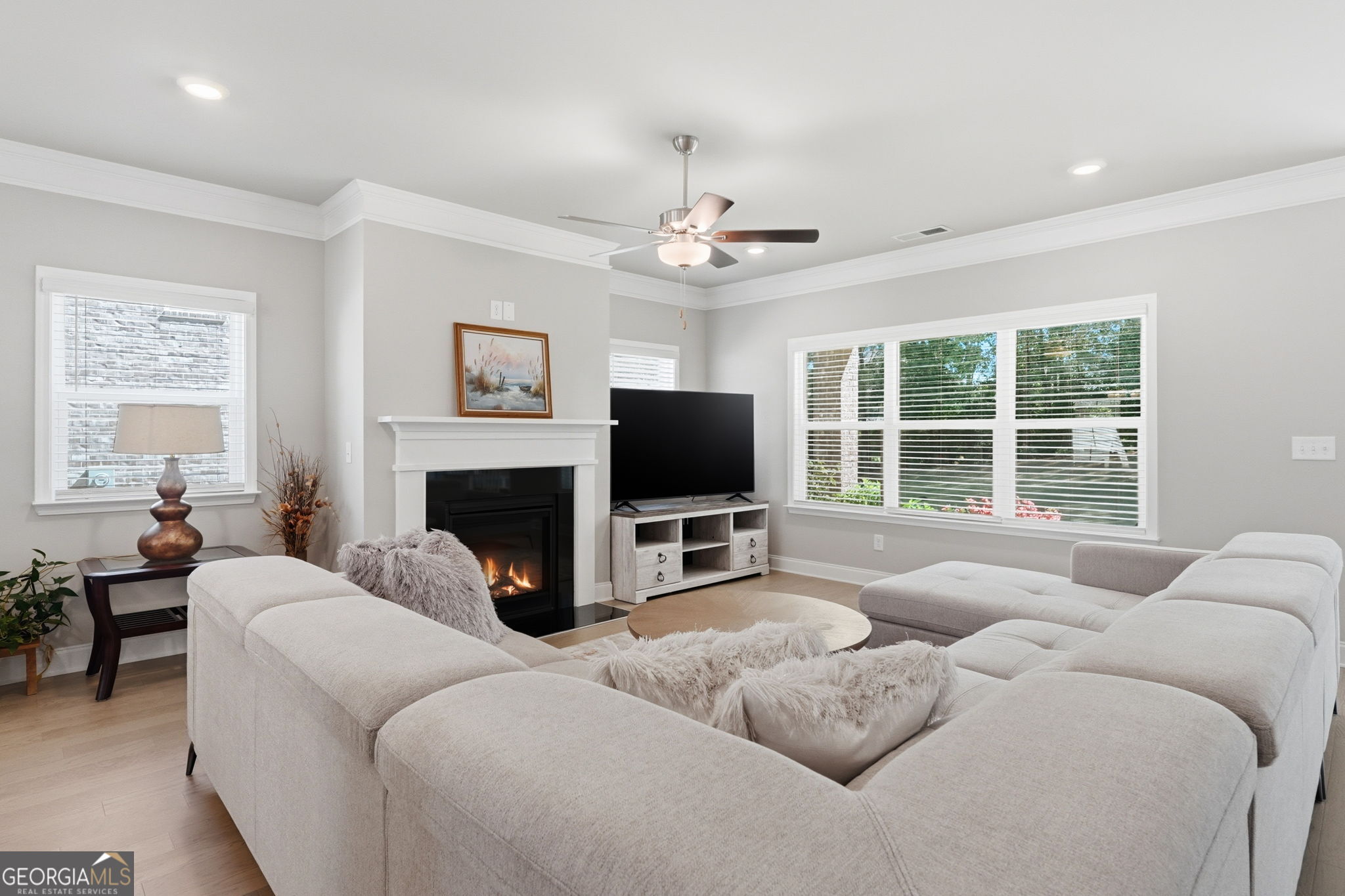 604 O'Brians Path McDonough, GA 30253 - Photo 8 of 41 a living room with furniture a flat screen tv and a fireplace