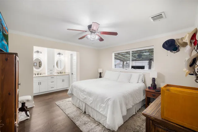 a bathroom with a granite countertop double vanity sink and a mirror