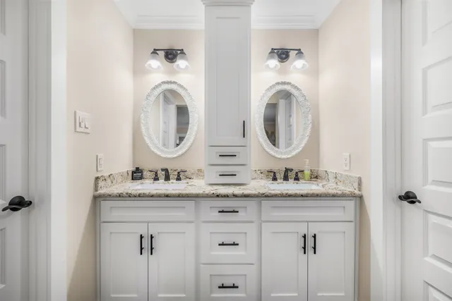a bathroom with a granite countertop toilet a sink and shower
