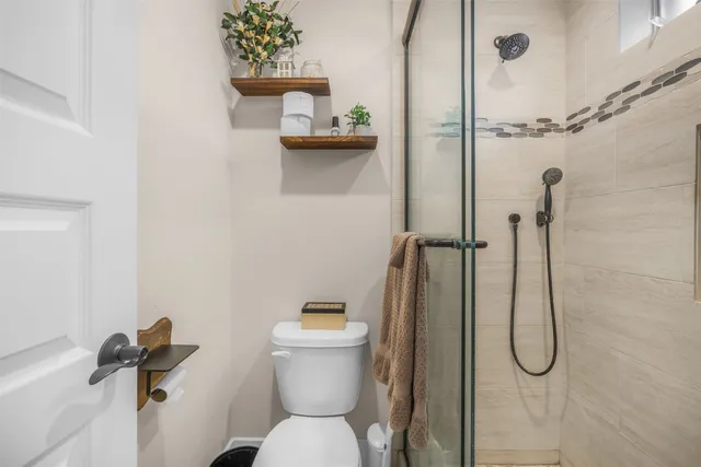 a bedroom with a bed next to a window with the outer view