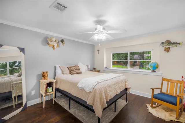 a bathroom with a granite countertop sink a toilet and shower curtain