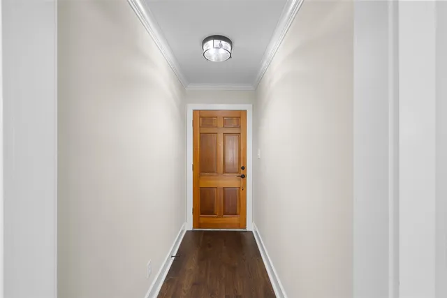 a view of an empty room with a fireplace and a window
