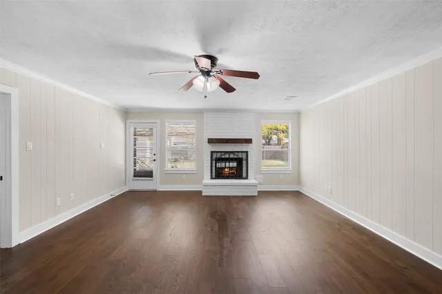 a living room with a fireplace and windows