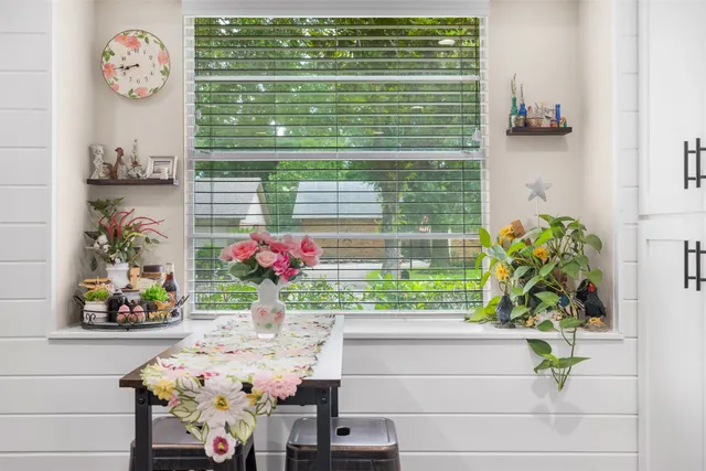 a view of a kitchen with kitchen island a large counter top space a sink stainless steel appliances and cabinets