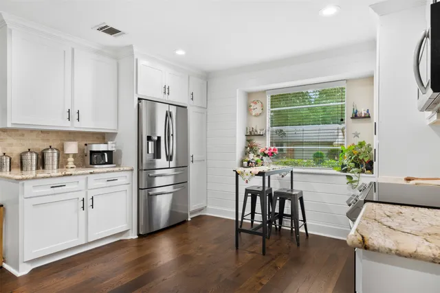 a kitchen with a table and chairs in it