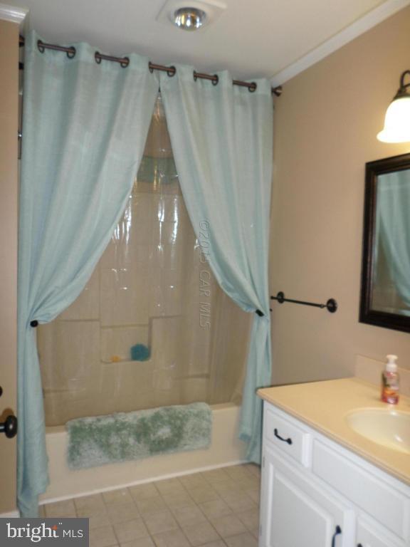 9018 Bethel Road Willards, MD 21874 - Photo 19 of 42 a bathroom with a granite countertop sink a mirror and shower