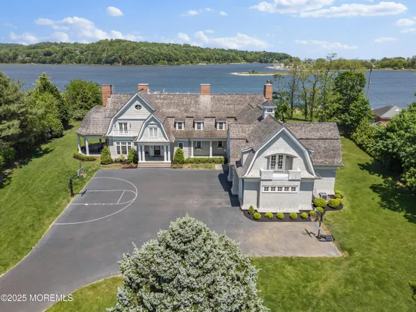 an aerial view of a house with outdoor space and lake view