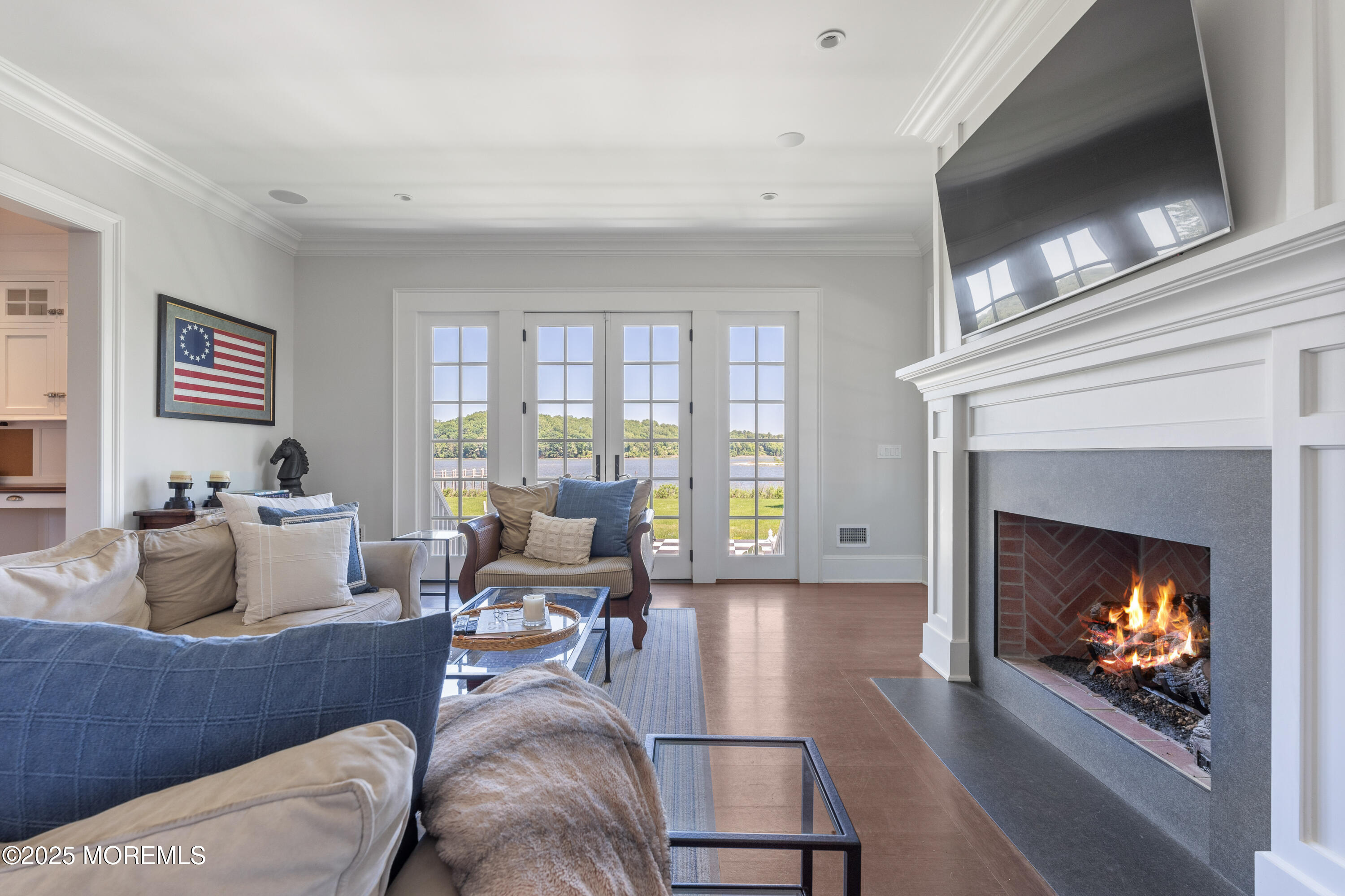 0 Wilson Circle Rumson, NJ 07760 - Photo 24 of 74 a living room with furniture a fireplace and a flat screen tv