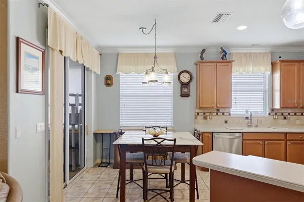 a large kitchen with a table and chairs