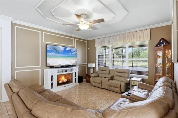 a living room with furniture a large window and a flat screen tv