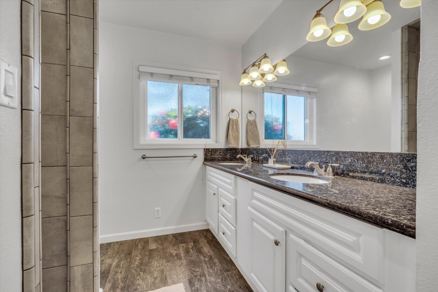 6450 Delta Avenue Tracy, CA 95304 - Photo 27 of 49 a bathroom with a sink a vanity and a mirror