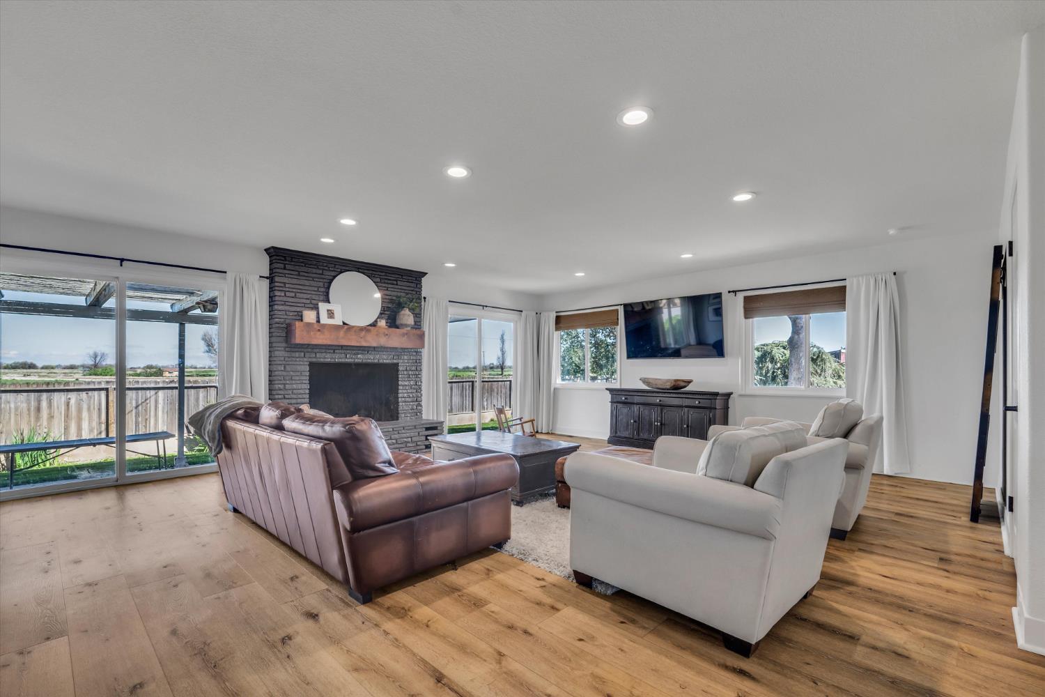 6450 Delta Avenue Tracy, CA 95304 - Photo 9 of 49 a living room with furniture a fireplace and a flat screen tv