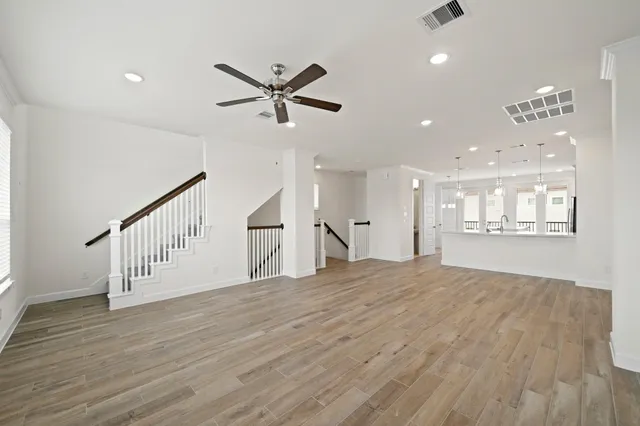 a view of an empty room and wooden floor