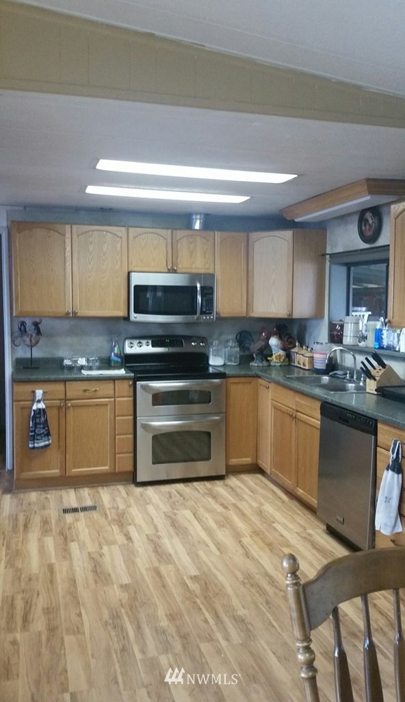 84564 Ringer Road Milton Freewater, OR 97862 - Photo 9 of 19 a kitchen with stainless steel appliances granite countertop a stove a sink and a microwave