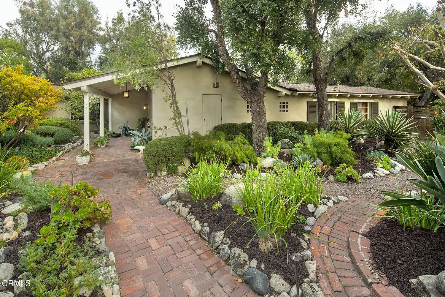 1126 Wotkyns Drive Pasadena, CA 91103 - Photo 22 of 31 a front view of a house with a garden