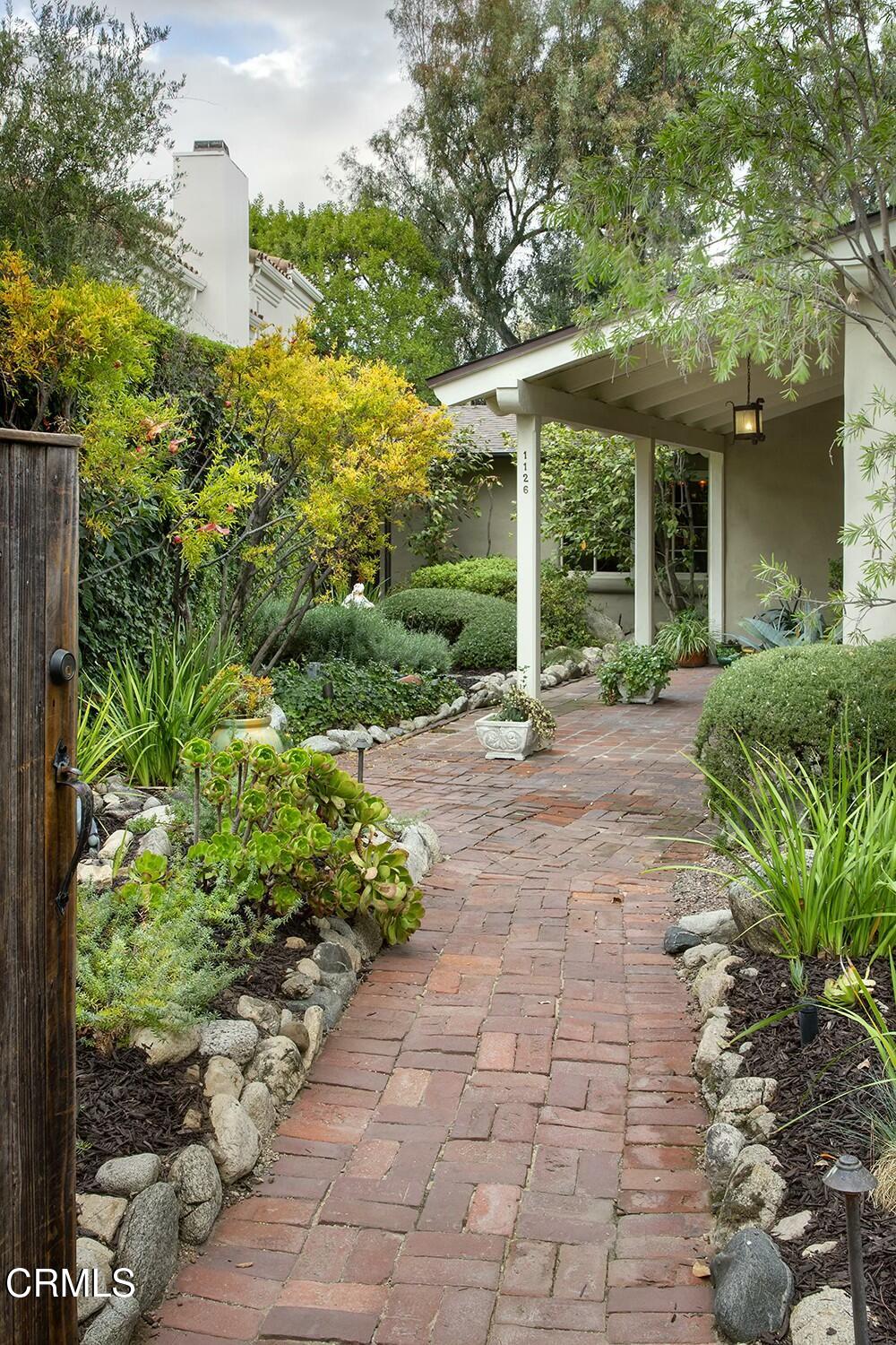 1126 Wotkyns Drive Pasadena, CA 91103 - Photo 23 of 31 a view of a house with garden and large tree