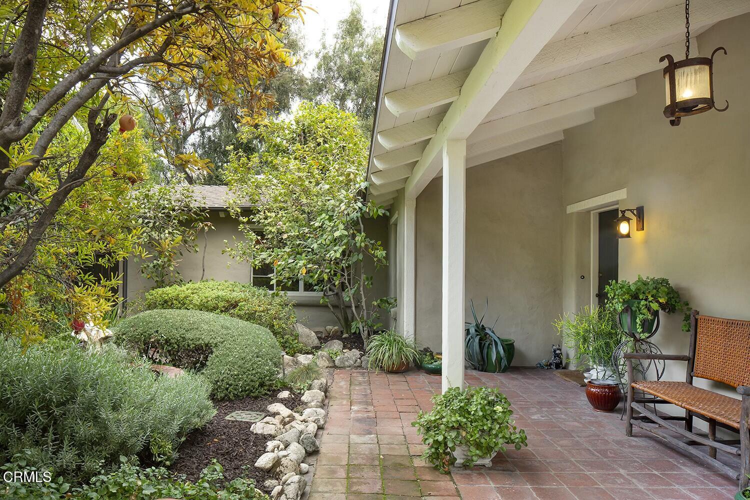 1126 Wotkyns Drive Pasadena, CA 91103 - Photo 4 of 31 a backyard with potted plants and a large tree