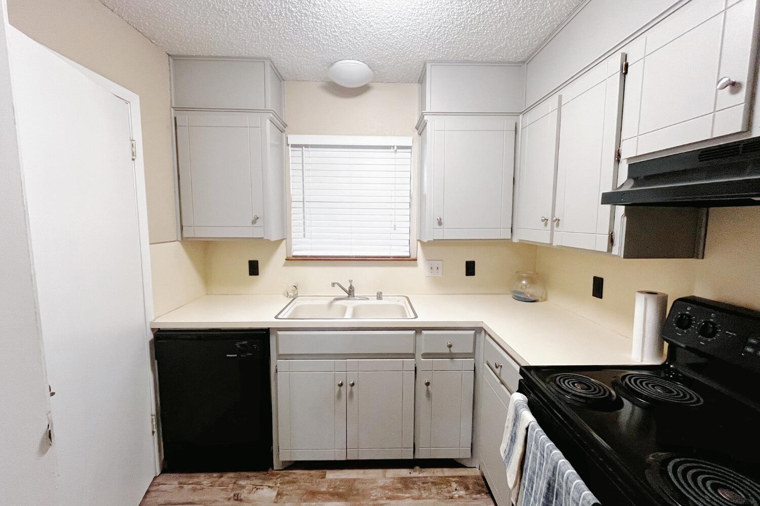 5806 7th Street Lubbock, TX 79416 - Photo 11 of 26 a kitchen with a sink stove and cabinets