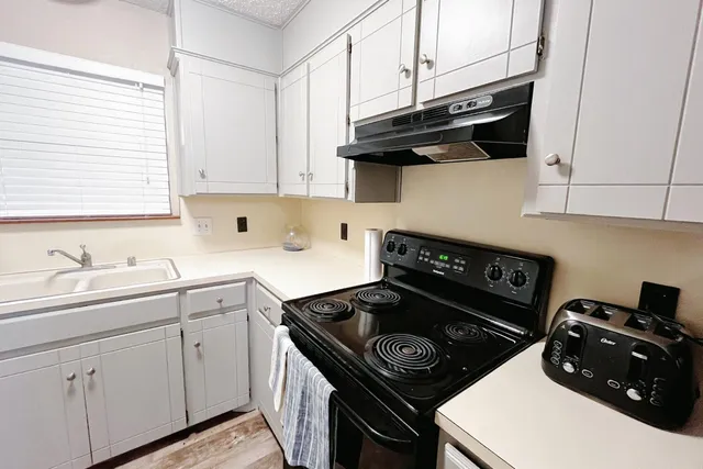 a kitchen with a stove and a sink