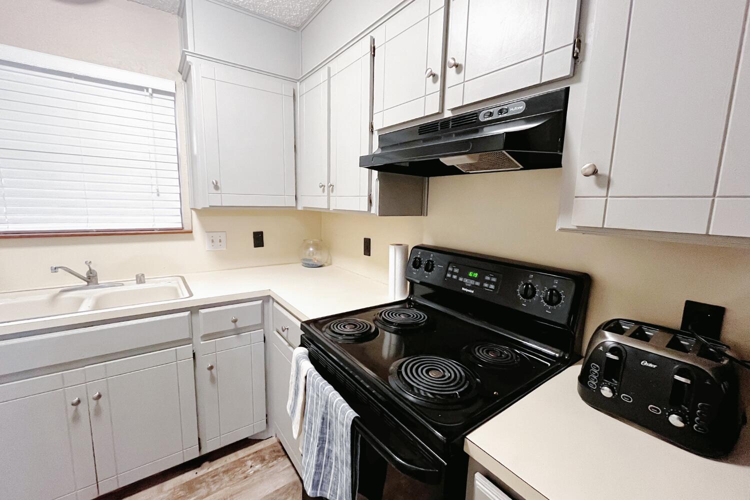 5806 7th Street Lubbock, TX 79416 - Photo 12 of 26 a kitchen with a stove and a sink