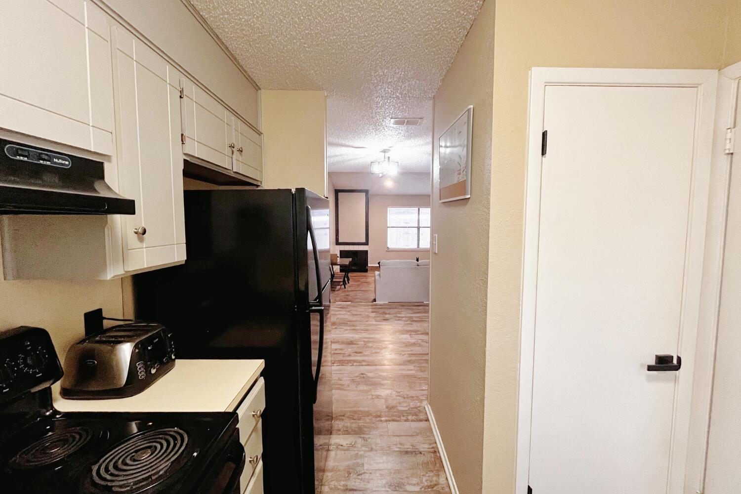 5806 7th Street Lubbock, TX 79416 - Photo 14 of 26 a kitchen with a refrigerator and a stove