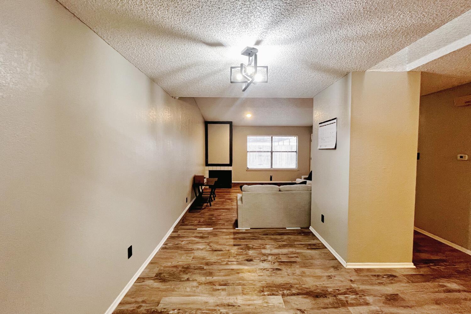 5806 7th Street Lubbock, TX 79416 - Photo 15 of 26 a view of a hallway with a chandelier