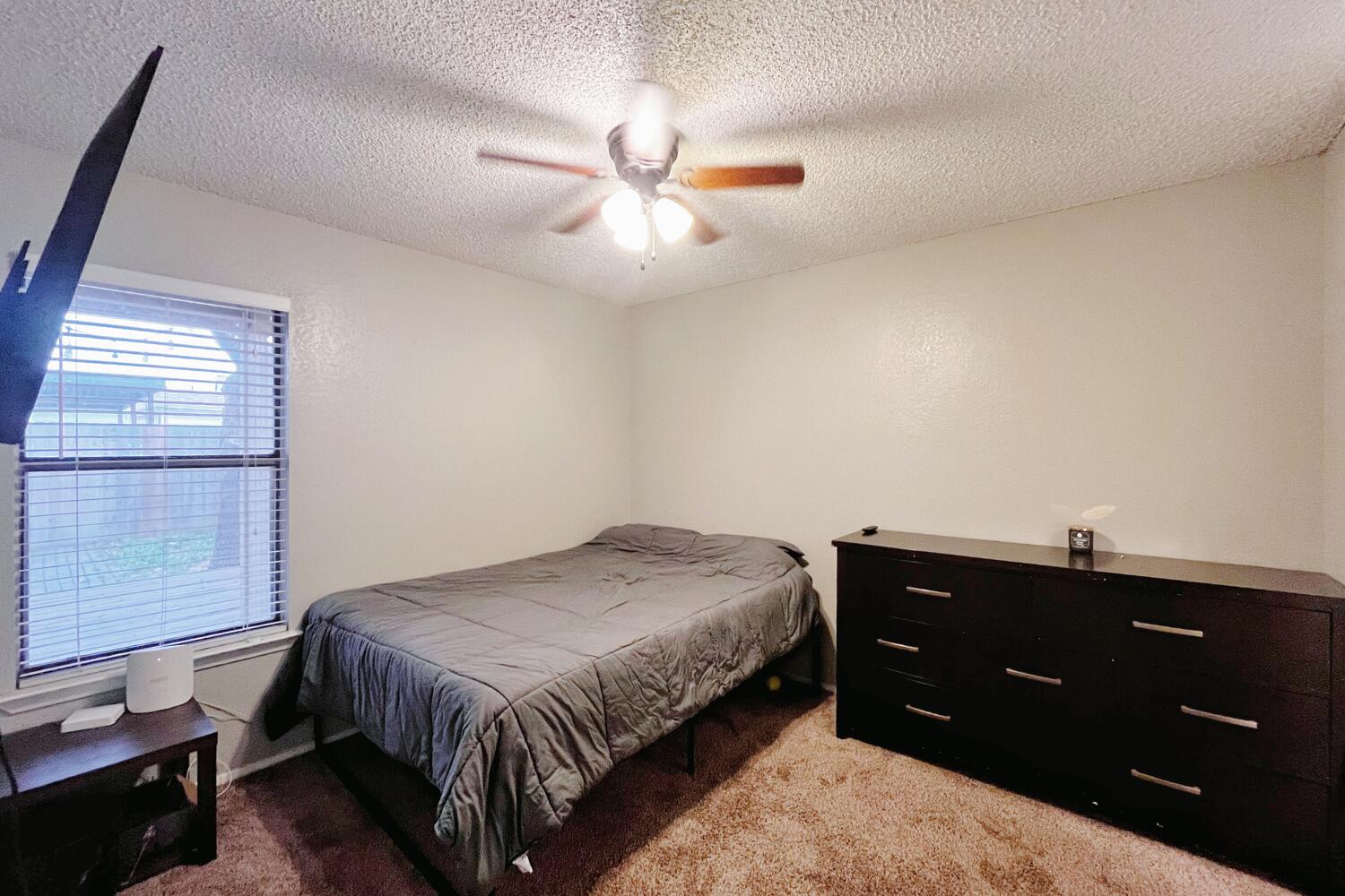 5806 7th Street Lubbock, TX 79416 - Photo 16 of 26 a bedroom with a bed and a window