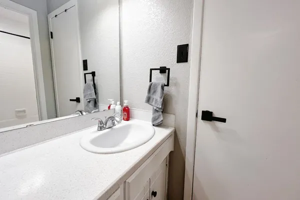 a bathroom with a sink and a mirror