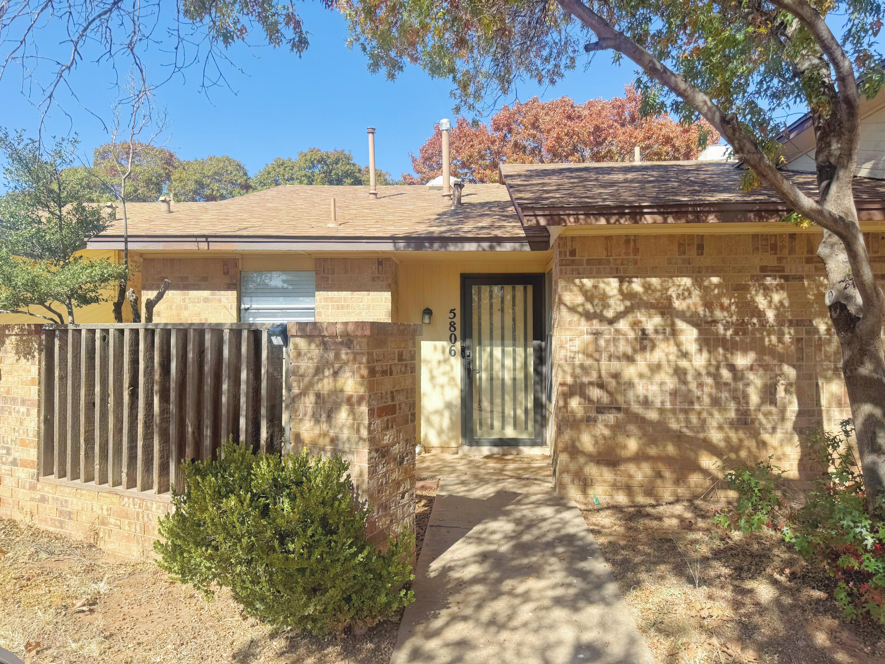 5806 7th Street Lubbock, TX 79416 - Photo 2 of 26 a view of a house with a small yard and wooden fence