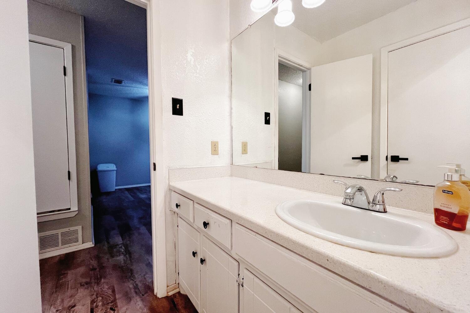 5806 7th Street Lubbock, TX 79416 - Photo 22 of 26 a bathroom with a double vanity sink and mirror