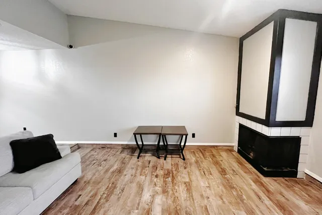 a view of a bedroom with furniture and wooden floor