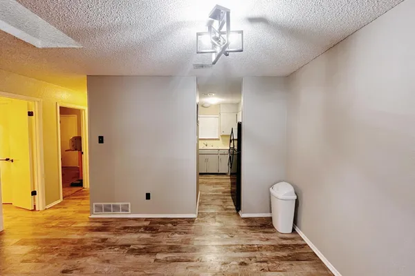 a view of a room with wooden floor and bathroom view