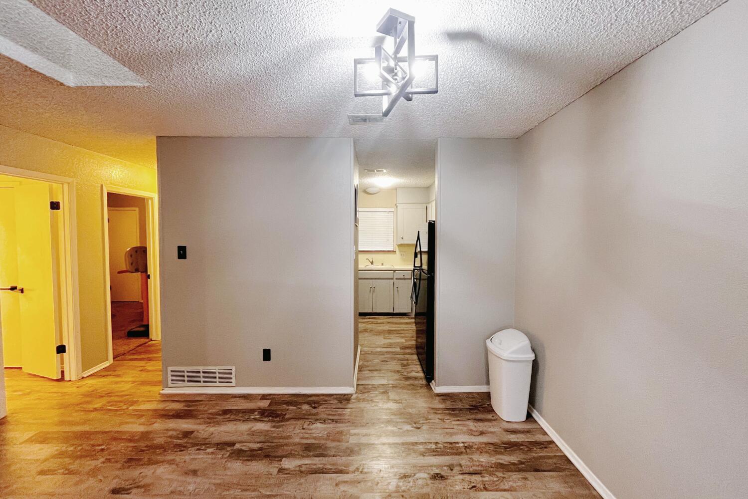 5806 7th Street Lubbock, TX 79416 - Photo 9 of 26 a view of a room with wooden floor and bathroom view