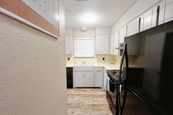 a kitchen with a sink stove and refrigerator