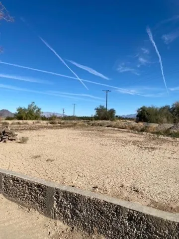 a living room with furniture and a refrigerator