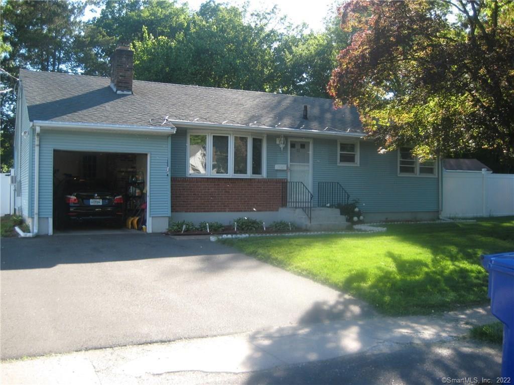 a view of a house with a yard and a patio