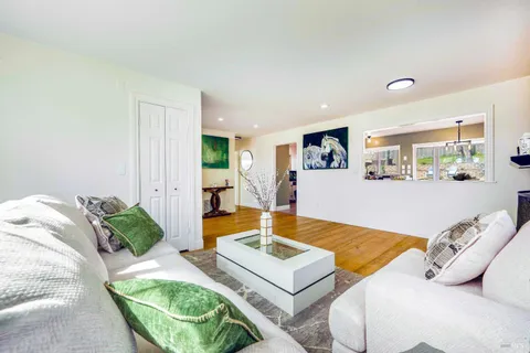 a kitchen with granite countertop a sink window and cabinets