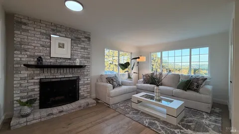 a living room with furniture and a floor to ceiling window