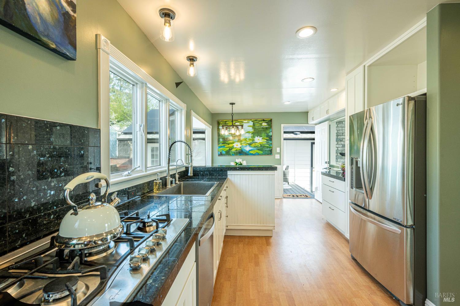 2693 Bloomfield Road Sebastopol, CA 95472 - Photo 23 of 61 a kitchen with stainless steel appliances granite countertop a refrigerator a stove and a wooden floors