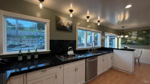 a dining room with furniture and potted plants