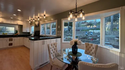 a view of a dining room with furniture and a potted plant