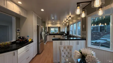 a view of a workspace with furniture and a window