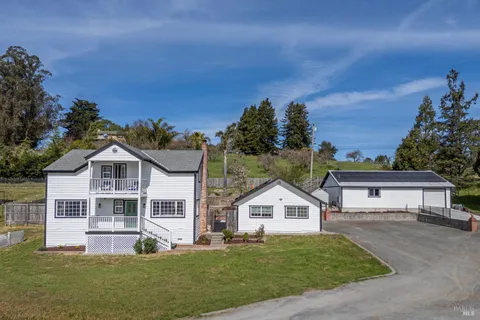 a view of a dry yard with mountains in the background