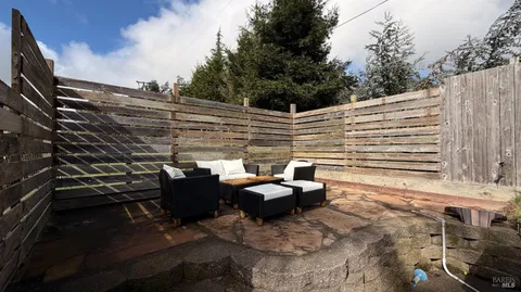 a dining room with furniture potted plants and wooden floor